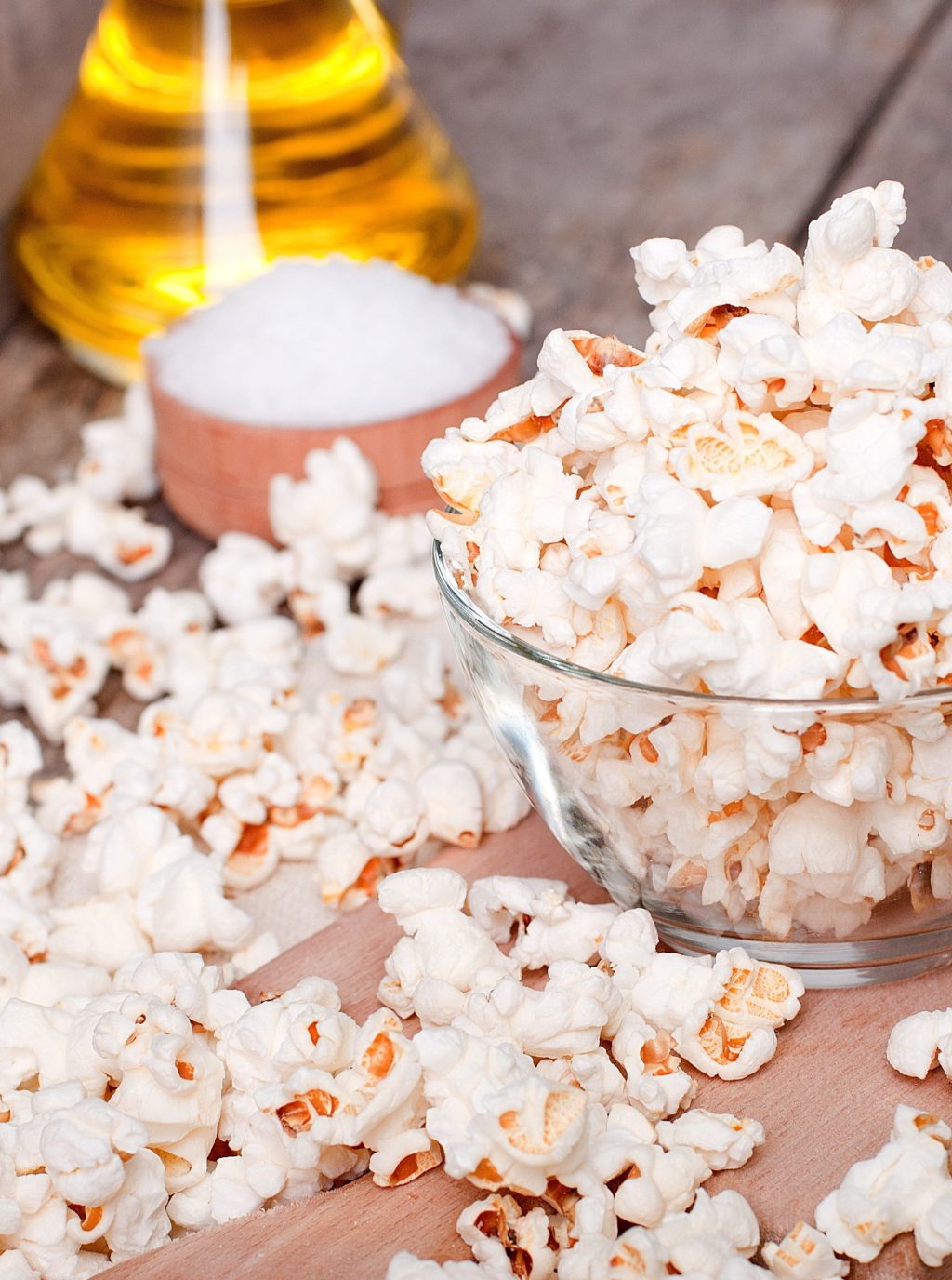 Popcorn that's popped in a glass bowl with olive oil.